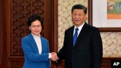 资料照:中国国家主席习近平与香港特区行政长官林郑月娥。(2019年12月16日)