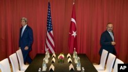 FILE - U.S. Secretary of State John Kerry, left, and Turkish Foreign Minister Mevlut Cavusoglu prepare to take part in a meeting ahead of the G20 summit in Hangzhou in eastern China's Zhejiang province, Sept. 3, 2016.