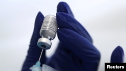 FILE PHOTO: A healthcare worker prepares a Pfizer coronavirus disease (COVID-19) vaccination in Los Angeles, Jan. 7, 2021.