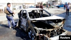 Chiếc xe bị hư hại sau một vụ tấn công bằng bom ở Kirkuk, giết chết 1 người và làm 16 người bị thương, 13/10/14