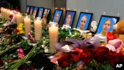 乌克兰基辅国际机场中为伊朗军队在德黑兰城外击落了一架乌克兰民航客机遇难者照片前摆放的鲜花和蜡烛。(2020年1月11日)