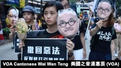2019年4月28日香港大游行的示威者手持在监狱服刑的邵家臻及戴耀廷的头像,代替他们出来游行 (美国之音汤惠芸 拍摄)