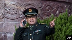 在北京人民大会堂外面,一位中国军官使用手机(2015年3月4日)