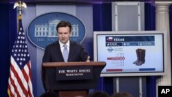 白宫发言人欧内斯特在白宫例行记者会上利用图像讨论TPP。(2015年10月13日)