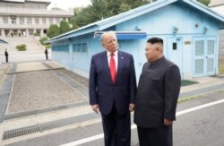 FILE - U.S. President Donald Trump meets with North Korean leader Kim Jong Un at the demilitarized zone separating the two Koreas, in Panmunjom, South Korea, June 30, 2019.