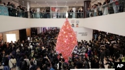 香港抗议者在圣诞节平安夜游行走过一家商场。(2019年12月24日)