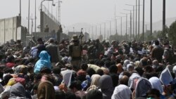 阿富汗人聚集在喀布尔机场军事区附近的一条道路旁,希望逃离塔利班的统治。(2021年8月20日)