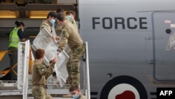 参加国际维和行动的新西兰军队士兵抵达动乱的所罗门群岛后从飞机上卸下装备。(2021年12月4日)