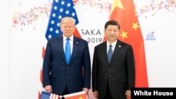 资料照:2019年6月29日,美国总统特朗普在日本大阪举行的二十国集团峰会上与中华人民共和国主席习近平举行双边会晤。