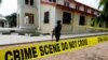 A police crime scene tape is seen in front of St. Francis Catholic Church where gunmen attacked worshippers during a Sunday mass service in Owo