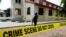 A police crime scene tape is seen in front of St. Francis Catholic Church where gunmen attacked worshippers during a Sunday mass service in Owo