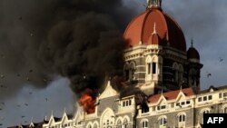A man with a Ukrainian flag walks past riot police standing guard during an anti-war rally in Moscow, Sept. 21, 2014.