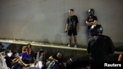 2024年10月1日,在伊朗向以色列发射弹道导弹后,警报响起,特拉维夫的人躲在路边一侧寻求保护。