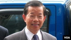 An opposition supporter looks on as he warms himself next to a fire in a barricade near Kyiv's Independence Square, Jan. 31, 2014.