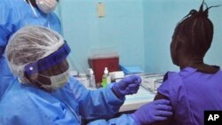 Phụ nữ Liberia được tiêm phòng vắc-xin chống Ebola thử nghiệm tại Monrovia.