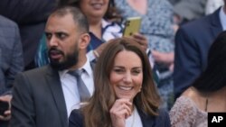 FILE - Britain's Kate, Duchess of Cambridge sits in the Royal Box on Centre Court on day five of the Wimbledon Tennis Championships in London. The Duchess of Cambridge is now self-isolating after a contact tested positive for the coronavirus.