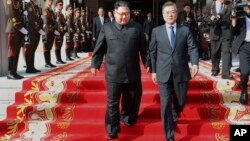 Britain's Prime Minister Boris Johnson, right, observes an early morning police raid on a home in Liverpool, England, ahead of the publication of the government's 10-year drug strategy.