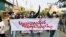 Students hold a banner and flash the three-finger salute as they take part in a protest against Myanmar’s junta, in Mandalay, Myanmar May 10, 2021. REUTERS/Stringer NO RESALES. NO ARCHIVES