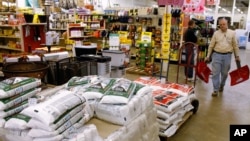 北卡罗来纳州一位居民在商店里手持铲雪锹走过促使冰雪融化的盐(2016年1月20日)