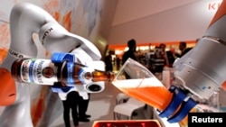 已被中国收购的德国机器人巨头“库卡”公司在汉诺威举行的工业展销会上展示机器人手臂倒一杯德国啤酒。(2017年4月24日)