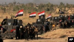 First lady Melania Trump is escorted by head teacher Maureen Masi as she arrives for a visits Chipala Primary School, in Lilongwe, Malawi, Oct. 4, 2018.