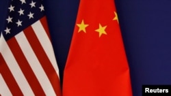 资料照片:时任美国总统特朗普与中国领导人习近平在北京人大会堂会晤工商界领导人时摆设的美中国旗。(2017年11月9日)