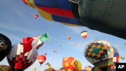 FILE - Thousands of spectators mingle among inflating hot air balloons at the 40th Albuquerque International Balloon Fiesta in Albuquerque, N.M., Oct. 2, 2011.