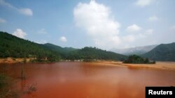 中国广东省北部大宝山附近呈棕红色的受污染湖泊。(2009年资料照)
