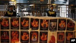 An Ethiopian Orthodox Christian priest holds a holy book for women to kiss at Deir El Sultan in the Church of the Holy Sepulcher, traditionally believed by many to be the site of the crucifixion and burial of Jesus Christ, during Palm Sunday services in Jerusalem's Old city.